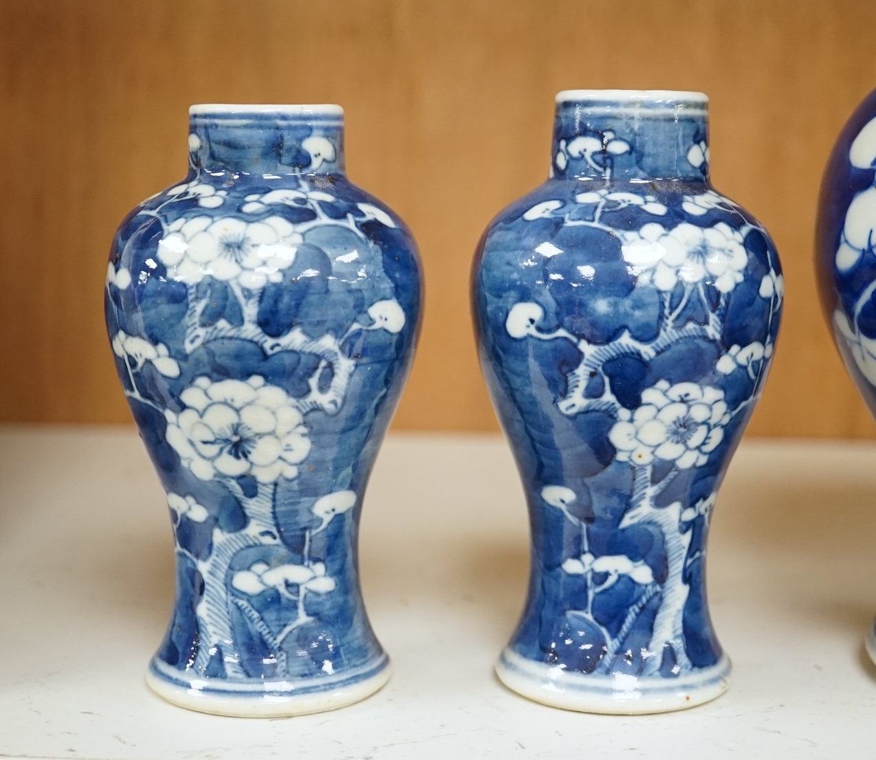 A group of five Chinese blue and white prunus vases, one with cover, late 19th century, tallest 20cm. Condition - varies